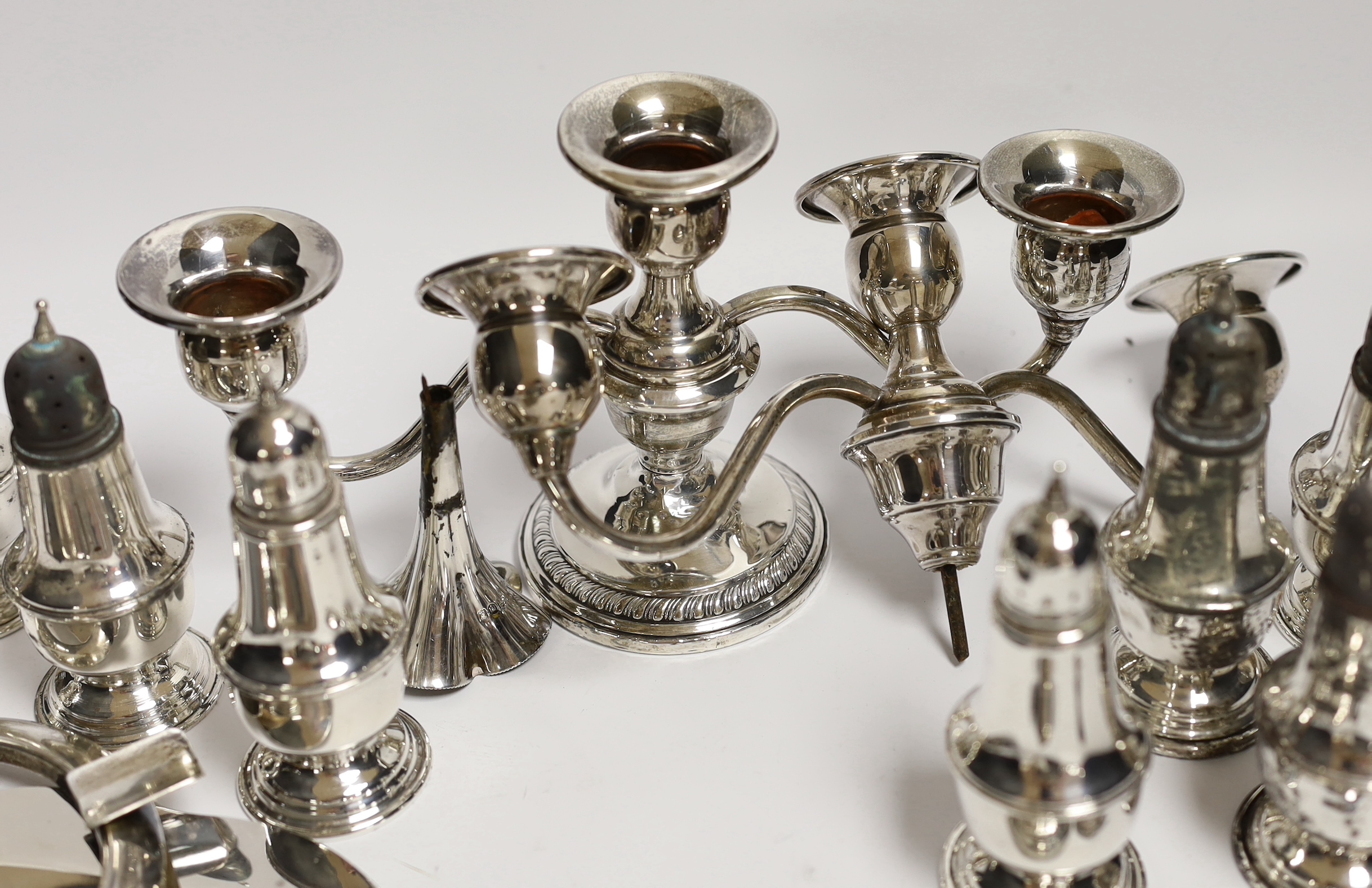 A quantity of assorted sterling or 800 standard white metal items including eight pepperettes, damaged pair of dwarf candelabra, sauceboat on stand etc.